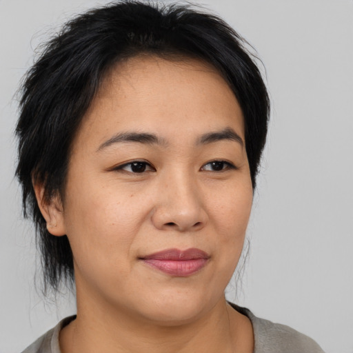 Joyful asian young-adult female with medium  black hair and brown eyes