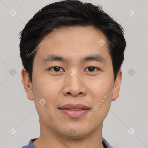 Joyful asian young-adult male with short  black hair and brown eyes