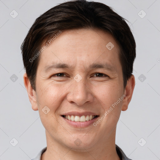 Joyful white adult male with short  brown hair and brown eyes