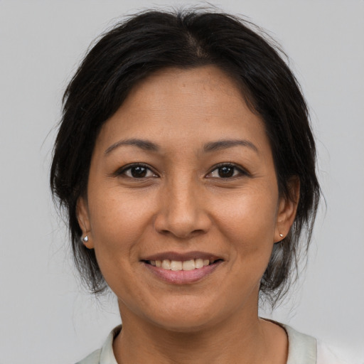 Joyful asian young-adult female with medium  brown hair and brown eyes