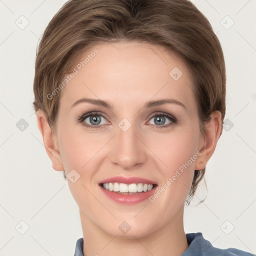 Joyful white young-adult female with medium  brown hair and grey eyes