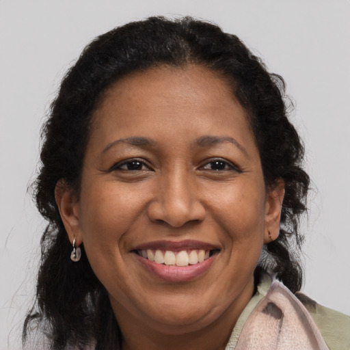 Joyful latino adult female with medium  brown hair and brown eyes