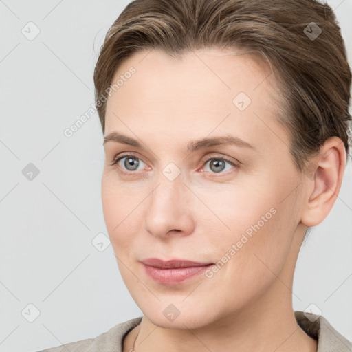 Joyful white young-adult female with short  brown hair and grey eyes