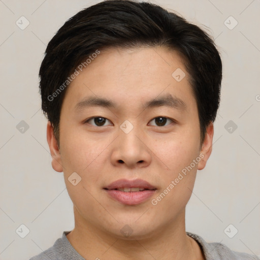 Joyful asian young-adult male with short  brown hair and brown eyes