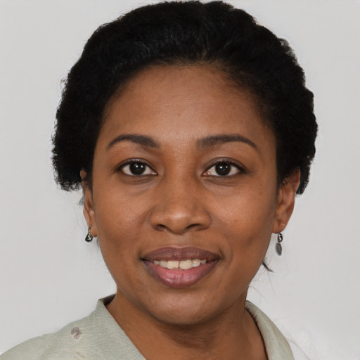 Joyful black adult female with short  black hair and brown eyes