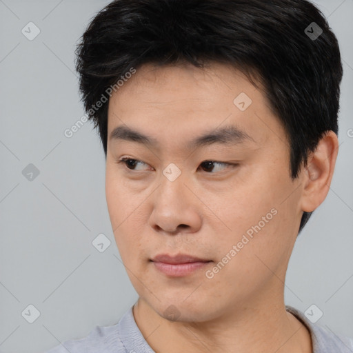Neutral asian young-adult male with short  black hair and brown eyes