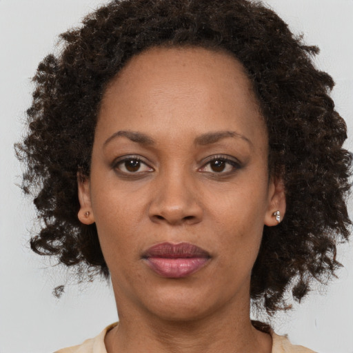 Neutral black adult female with medium  brown hair and brown eyes