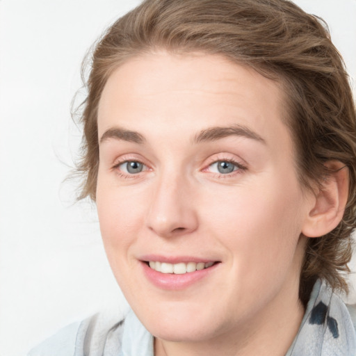 Joyful white young-adult female with medium  brown hair and blue eyes