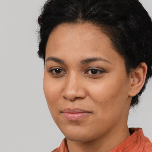 Joyful latino young-adult female with short  brown hair and brown eyes
