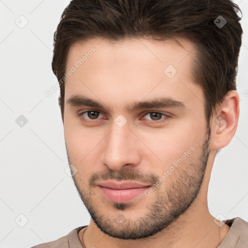 Joyful white young-adult male with short  brown hair and brown eyes