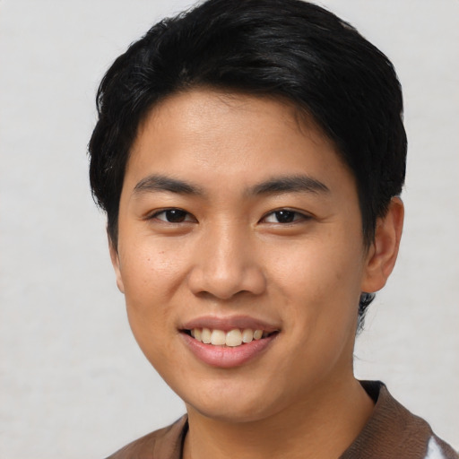 Joyful asian young-adult female with short  black hair and brown eyes