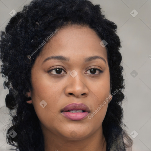 Joyful black young-adult female with long  black hair and brown eyes