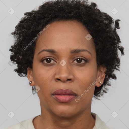 Joyful black adult female with short  brown hair and brown eyes