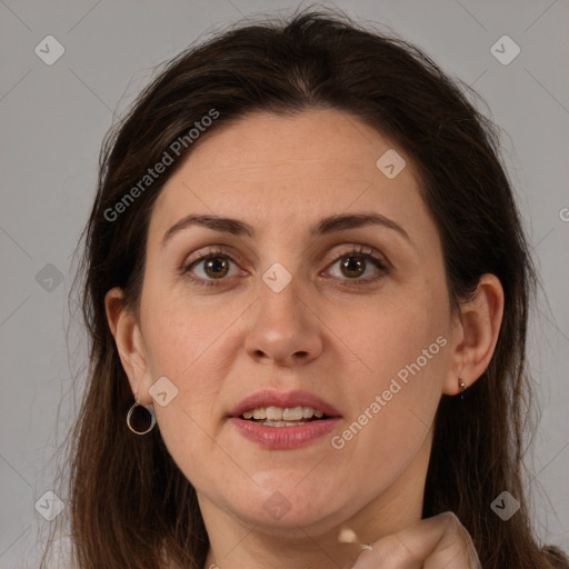 Joyful white adult female with long  brown hair and grey eyes