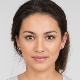 Joyful white young-adult female with medium  brown hair and brown eyes