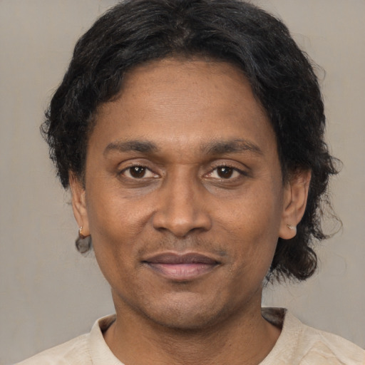 Joyful latino adult male with short  black hair and brown eyes