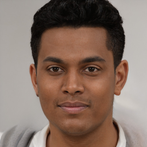 Joyful latino young-adult male with short  black hair and brown eyes