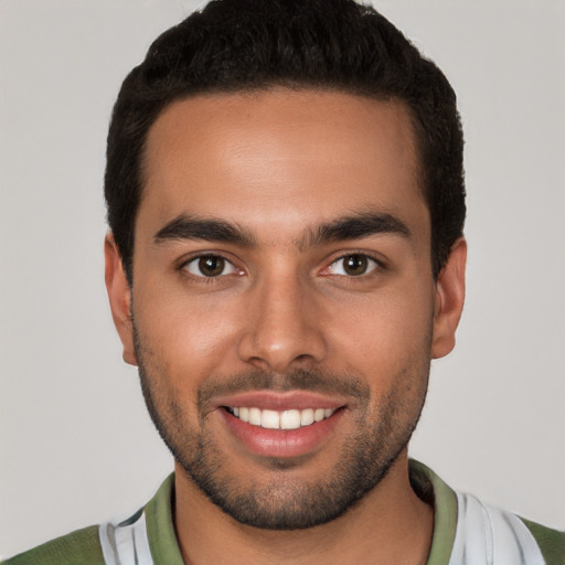 Joyful white young-adult male with short  black hair and brown eyes