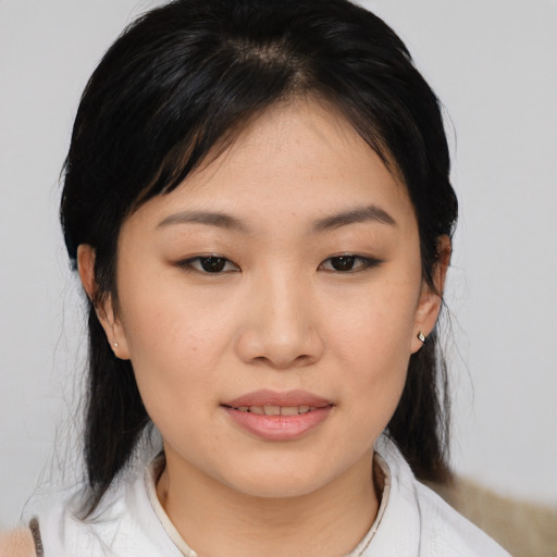 Joyful asian young-adult female with medium  black hair and brown eyes