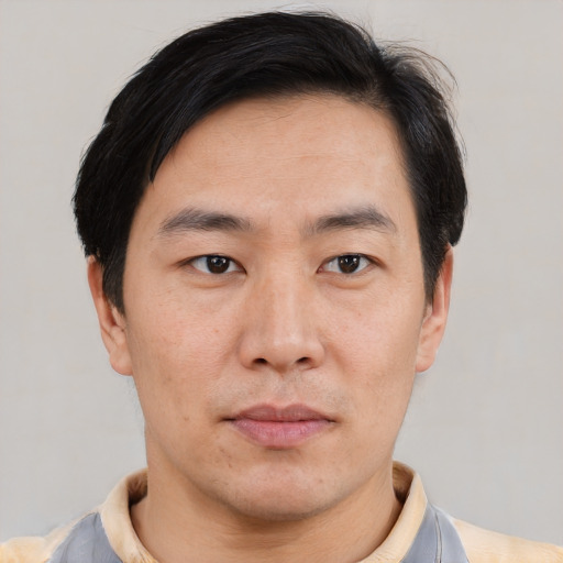 Neutral asian adult male with short  brown hair and brown eyes