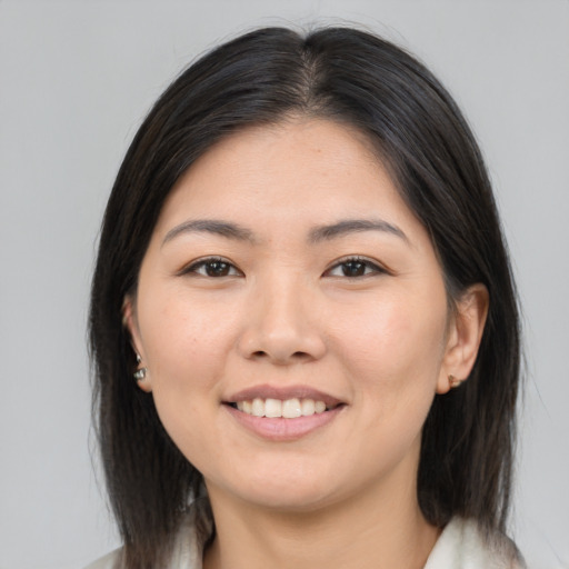 Joyful asian young-adult female with medium  brown hair and brown eyes