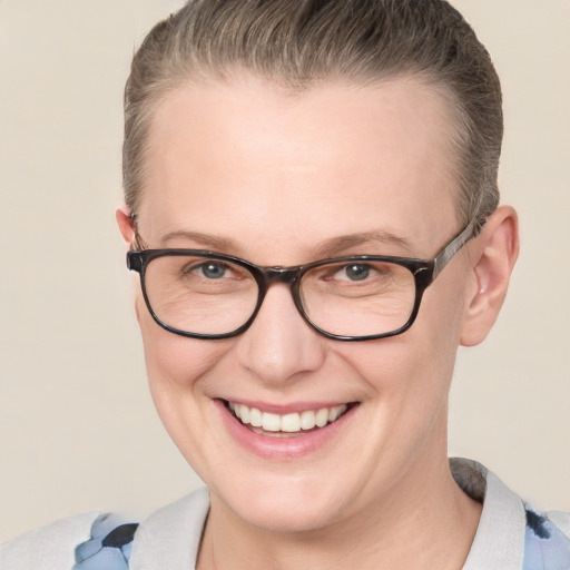 Joyful white adult female with short  brown hair and blue eyes