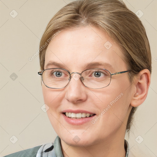 Joyful white adult female with medium  brown hair and blue eyes