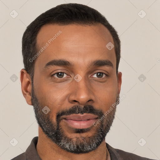 Joyful black young-adult male with short  brown hair and brown eyes