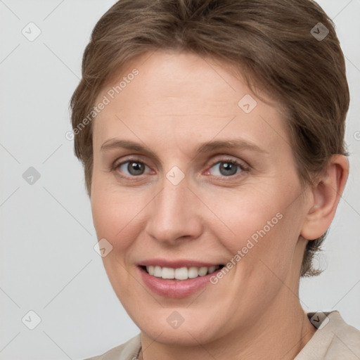 Joyful white young-adult female with short  brown hair and grey eyes