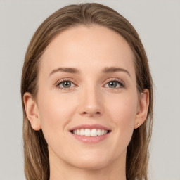 Joyful white young-adult female with long  brown hair and grey eyes