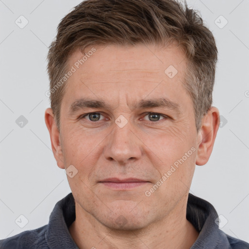 Joyful white adult male with short  brown hair and grey eyes