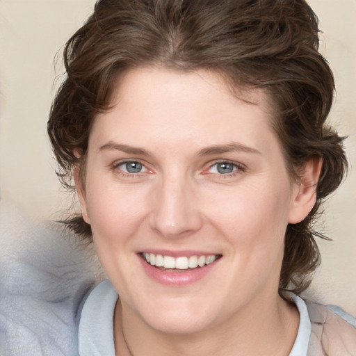 Joyful white young-adult female with medium  brown hair and blue eyes