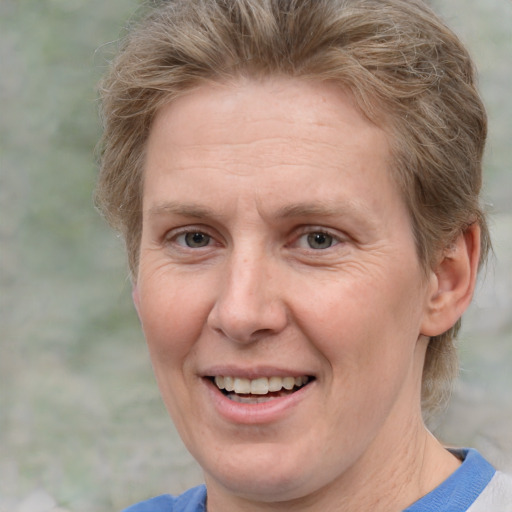 Joyful white adult female with short  brown hair and grey eyes