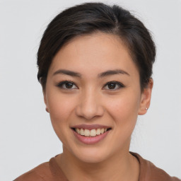 Joyful asian young-adult female with short  brown hair and brown eyes