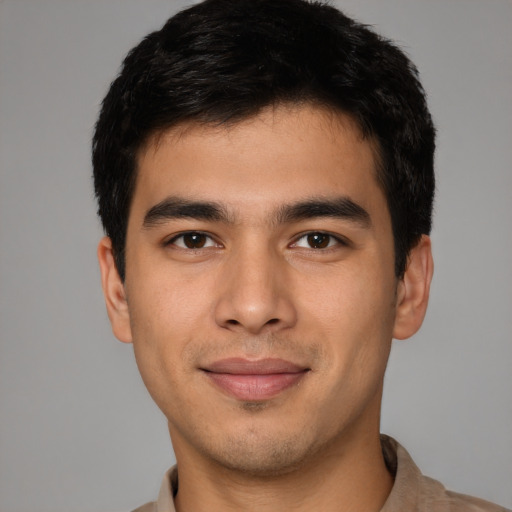 Joyful asian young-adult male with short  black hair and brown eyes