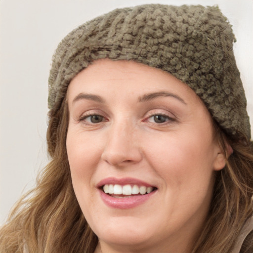 Joyful white young-adult female with long  brown hair and blue eyes