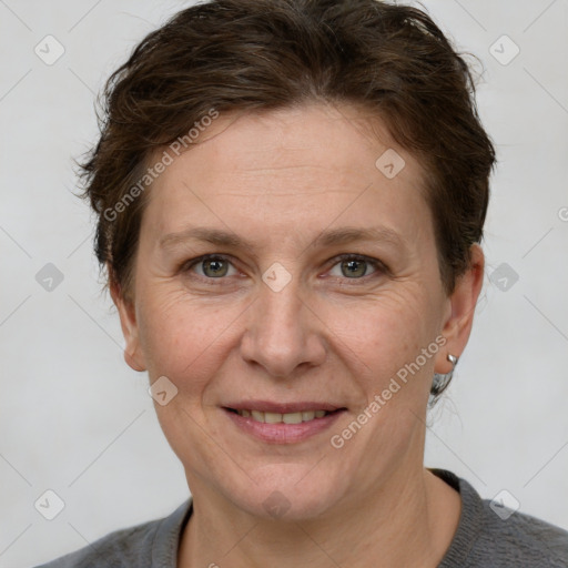 Joyful white adult female with short  brown hair and grey eyes