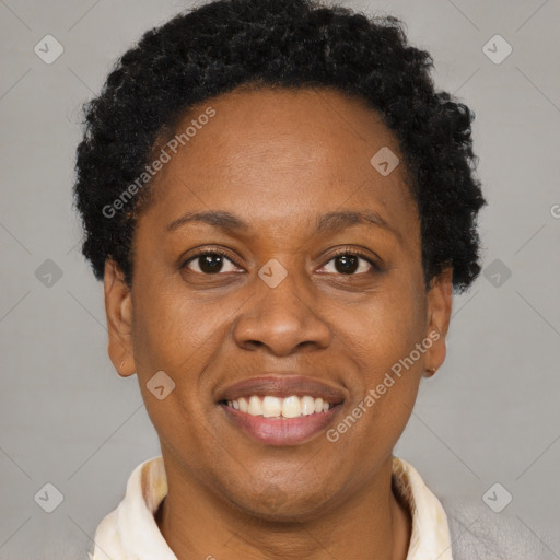 Joyful black adult female with short  brown hair and brown eyes