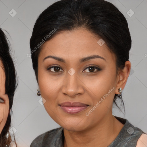 Joyful latino young-adult female with medium  brown hair and brown eyes