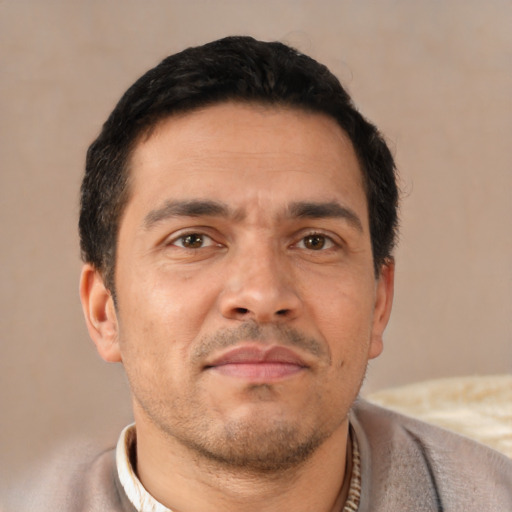 Neutral latino adult male with short  black hair and brown eyes