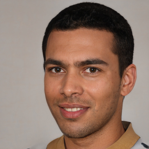 Joyful white young-adult male with short  black hair and brown eyes