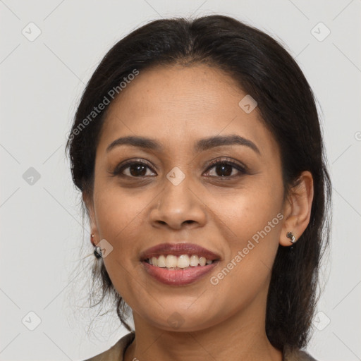 Joyful latino young-adult female with long  brown hair and brown eyes