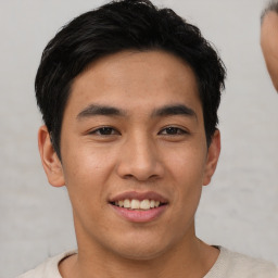 Joyful asian young-adult male with short  black hair and brown eyes