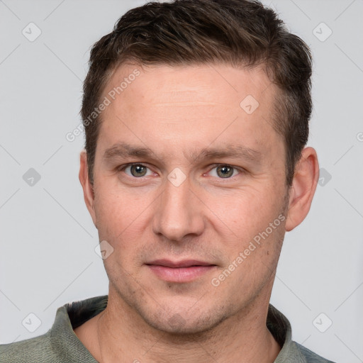 Joyful white adult male with short  brown hair and grey eyes