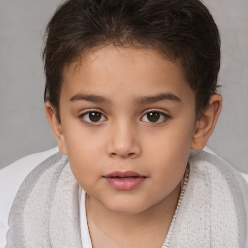 Joyful white child female with short  brown hair and brown eyes