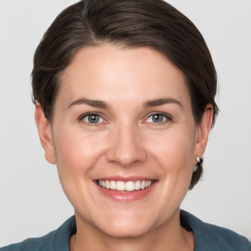 Joyful white young-adult female with short  brown hair and grey eyes