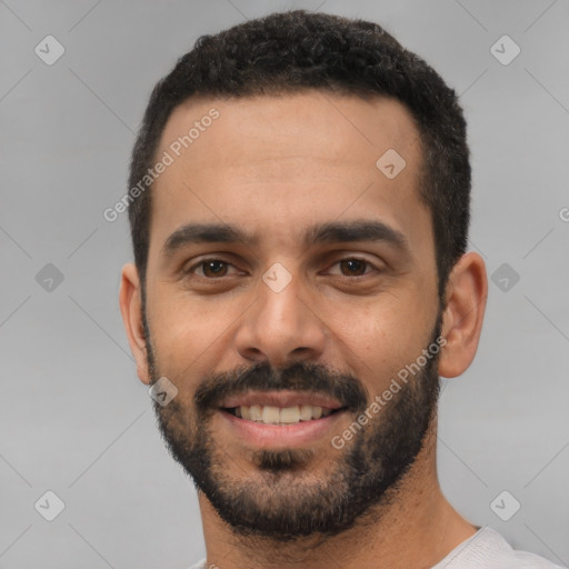 Joyful white young-adult male with short  black hair and brown eyes