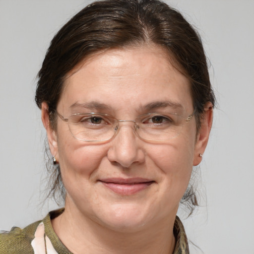 Joyful white adult female with medium  brown hair and brown eyes