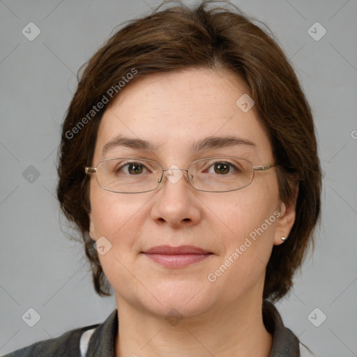 Joyful white adult female with medium  brown hair and green eyes