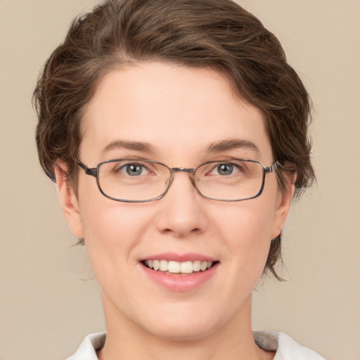 Joyful white young-adult female with short  brown hair and green eyes